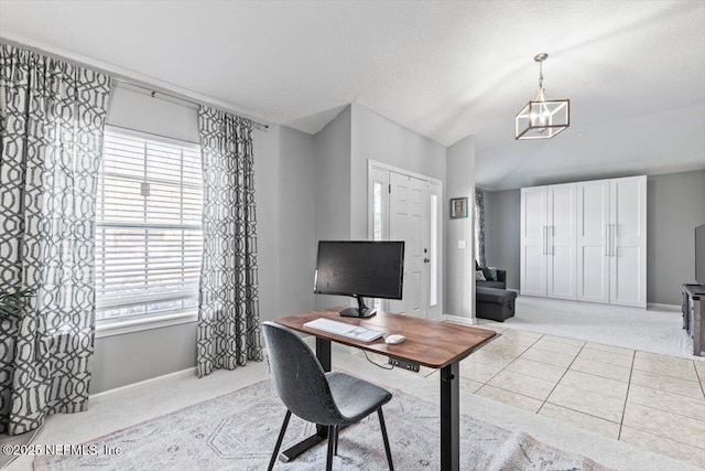 office space with light tile patterned floors, a textured ceiling, baseboards, and vaulted ceiling