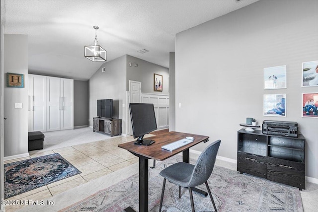 tiled office with visible vents, baseboards, a textured ceiling, and lofted ceiling