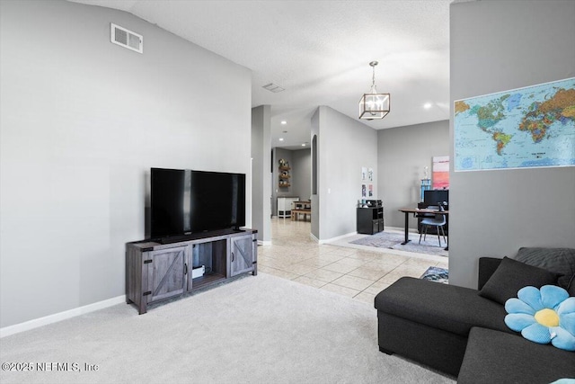 carpeted living area with tile patterned flooring, visible vents, recessed lighting, and baseboards