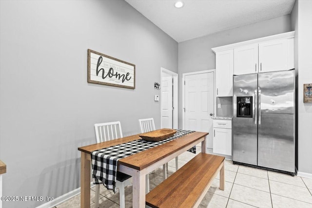 dining room with light tile patterned floors and baseboards