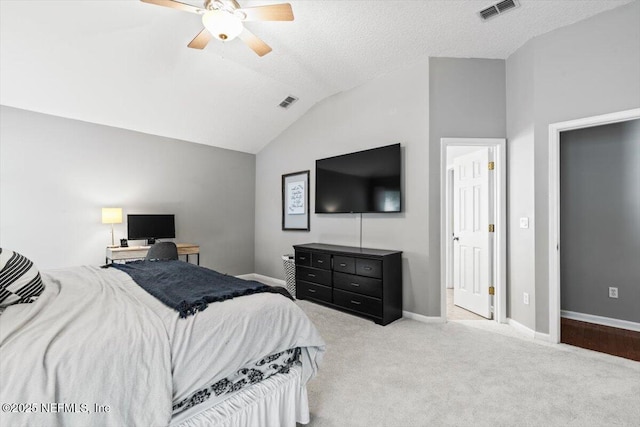 carpeted bedroom with visible vents, a ceiling fan, a textured ceiling, baseboards, and vaulted ceiling