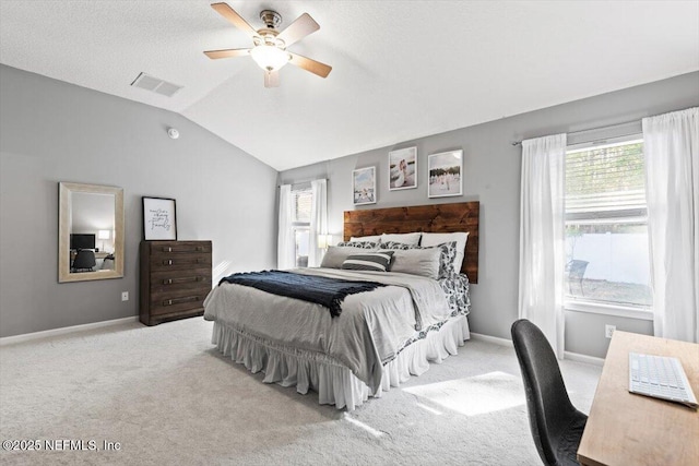 bedroom with baseboards, visible vents, carpet floors, lofted ceiling, and ceiling fan