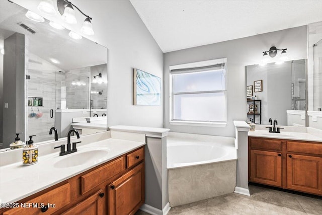 bathroom with lofted ceiling, a stall shower, and a sink