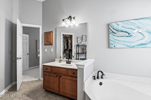 full bath with a bath, tile patterned flooring, and vanity