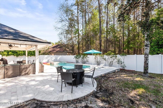 view of patio with a fenced in pool, a fenced backyard, and a ceiling fan