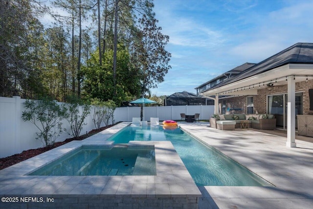 view of swimming pool featuring an outdoor living space, a pool with connected hot tub, a fenced backyard, and a patio area