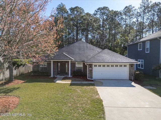 view of front facade with a front yard, fence, roof with shingles, concrete driveway, and a garage