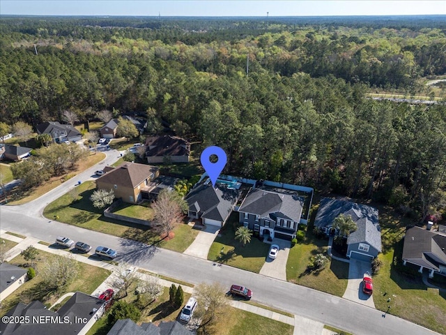 birds eye view of property featuring a residential view and a view of trees