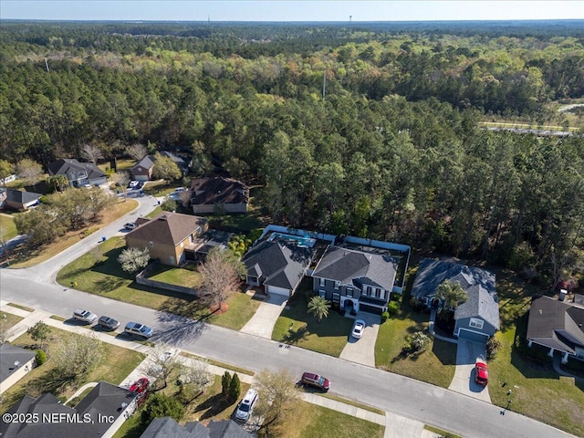 birds eye view of property featuring a forest view and a residential view