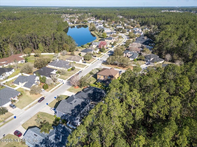 aerial view featuring a view of trees, a water view, and a residential view