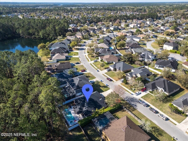 drone / aerial view featuring a residential view and a water view