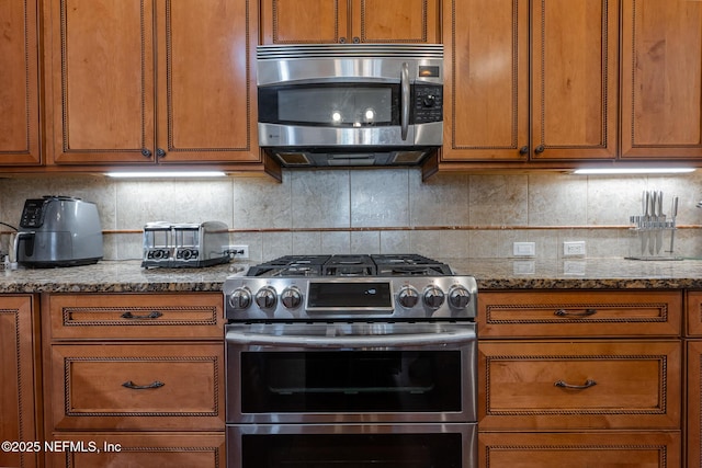 3808 Catania Pl, Jacksonville, FL 32224 - kitchen featuring stone counters, brown cabinets, tasteful backsplash, and appliances with stainless steel finishes