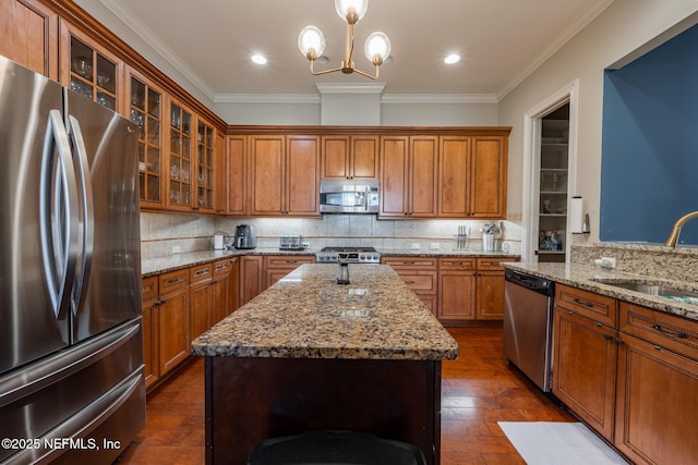 3808 Catania Pl, Jacksonville, FL 32224 - kitchen with brown cabinetry, stainless steel appliances, crown molding, and a sink