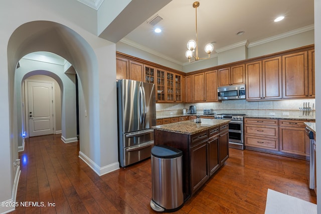 3808 Catania Pl, Jacksonville, FL 32224 - kitchen with light stone counters, visible vents, dark wood finished floors, and appliances with stainless steel finishes