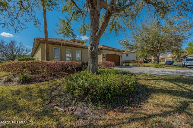 3808 Catania Pl, Jacksonville, FL 32224 - view of front of home featuring stucco siding, a garage, concrete driveway, and a tiled roof