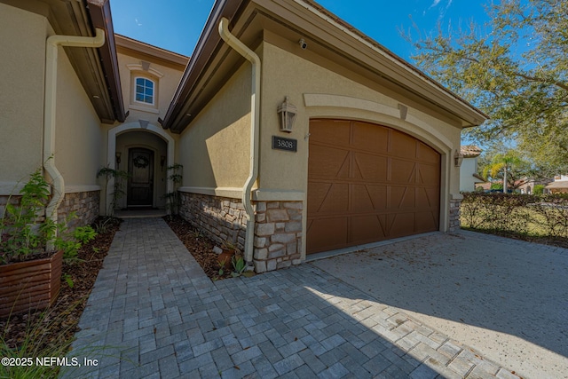 3808 Catania Pl, Jacksonville, FL 32224 - exterior space with a garage, stone siding, driveway, and stucco siding