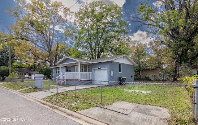 view of front facade with a front lawn, an attached garage, driveway, and a fenced front yard