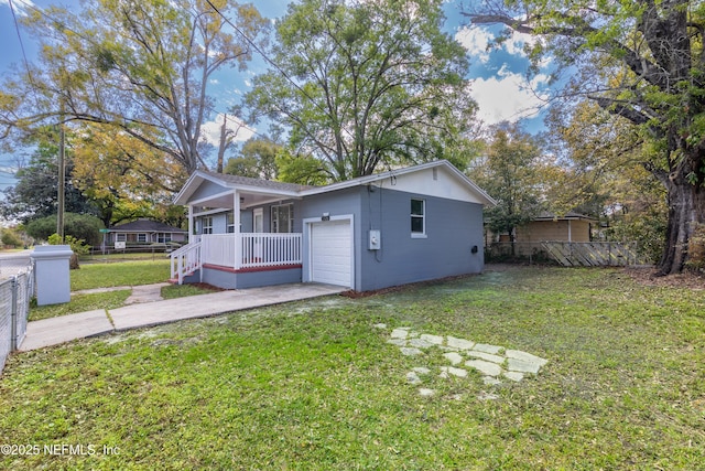 back of house with fence, concrete driveway, covered porch, a garage, and a yard