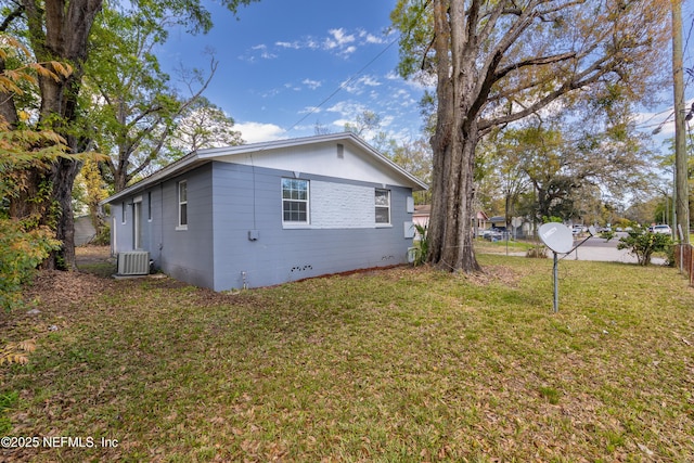 view of side of property featuring central air condition unit, a lawn, and fence