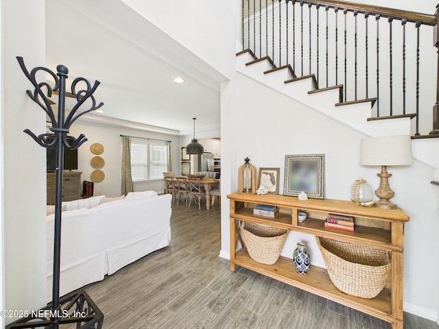 foyer with stairs, recessed lighting, wood finished floors, and baseboards