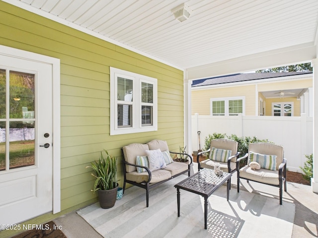 view of patio featuring an outdoor living space and fence
