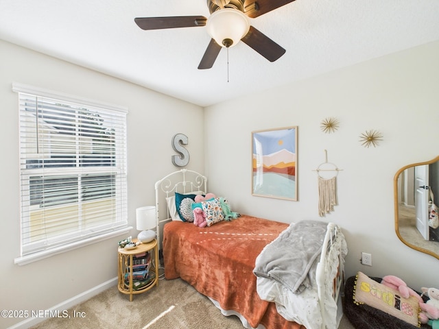 bedroom featuring ceiling fan, baseboards, and carpet