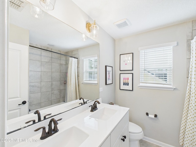 full bathroom featuring visible vents, toilet, and a sink