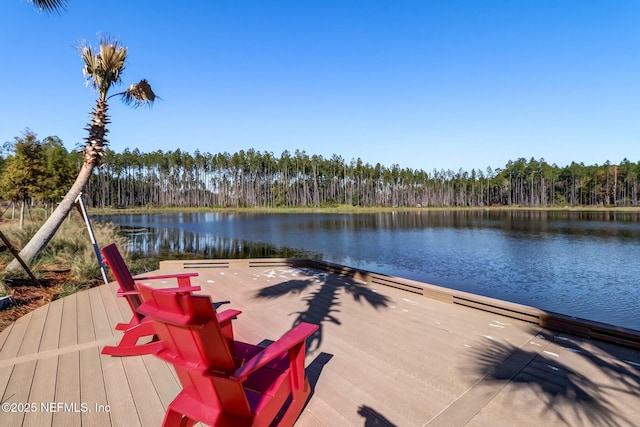 dock area with a forest view and a water view