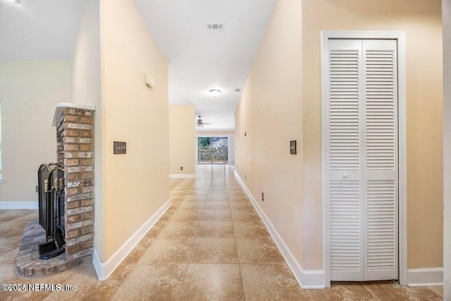 hallway with visible vents and baseboards