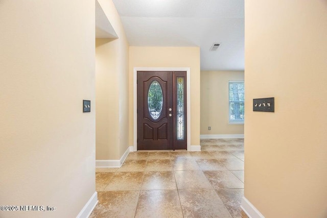 foyer entrance featuring visible vents and baseboards