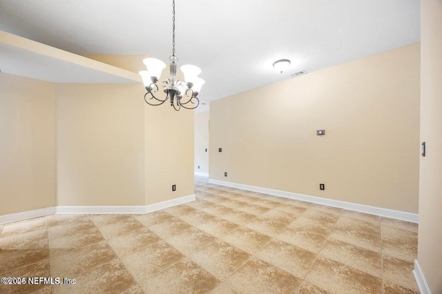 empty room featuring visible vents, baseboards, and a notable chandelier