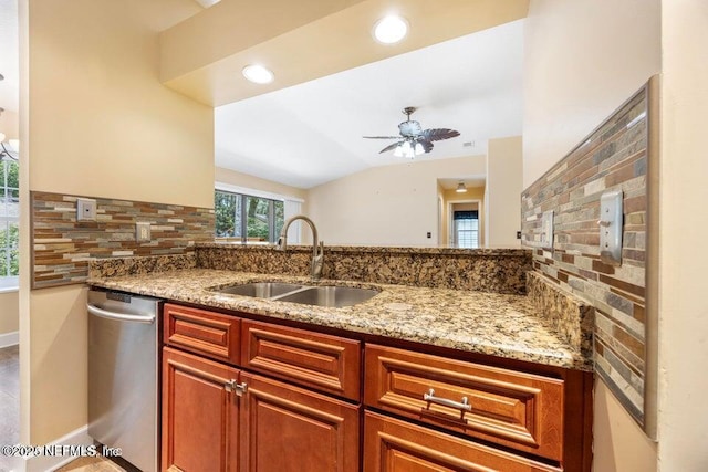 kitchen with a ceiling fan, light stone countertops, a sink, vaulted ceiling, and dishwasher