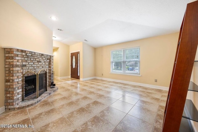 unfurnished living room featuring visible vents, baseboards, and a fireplace