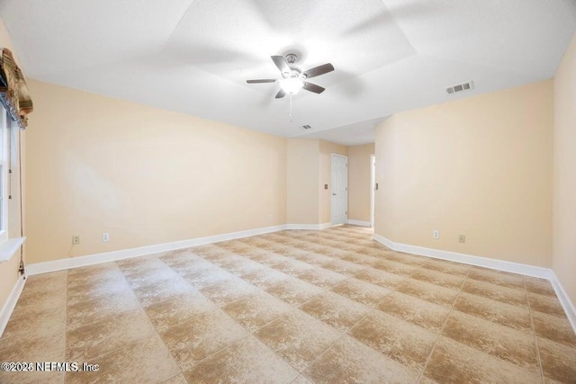 spare room with visible vents, baseboards, and ceiling fan