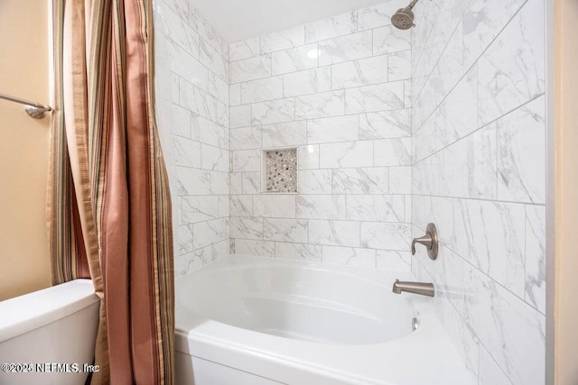 bathroom featuring shower / bath combination with curtain and toilet