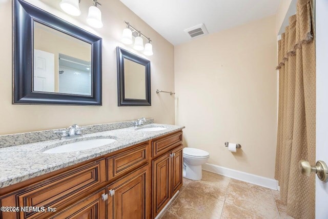 full bath with a sink, visible vents, toilet, and double vanity