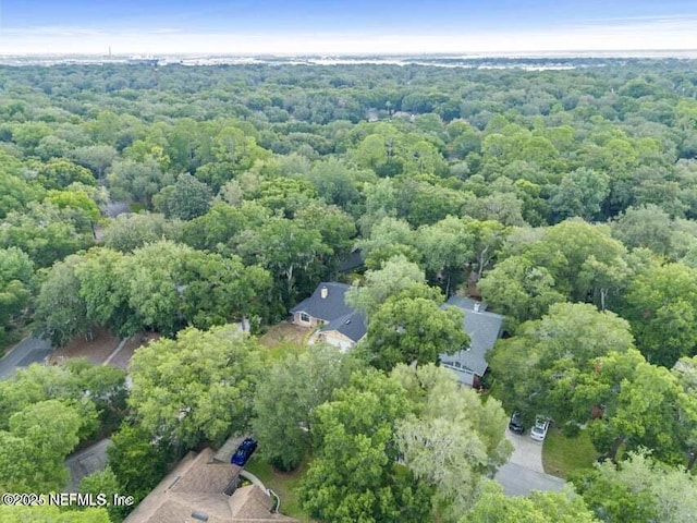 bird's eye view featuring a wooded view