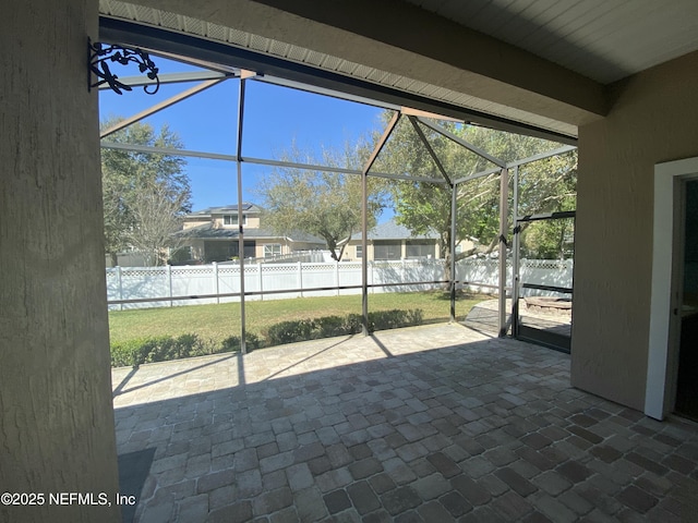 unfurnished sunroom featuring beam ceiling