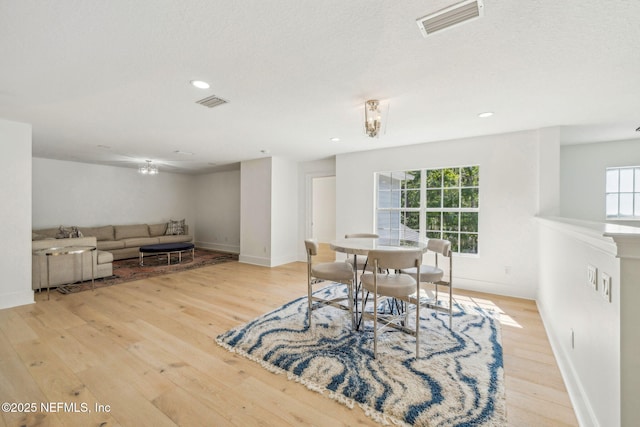 dining space featuring visible vents, baseboards, and hardwood / wood-style floors