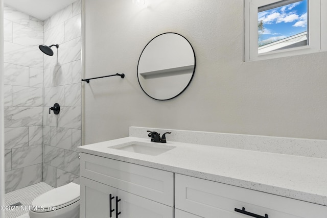 full bath featuring a stall shower, toilet, and vanity