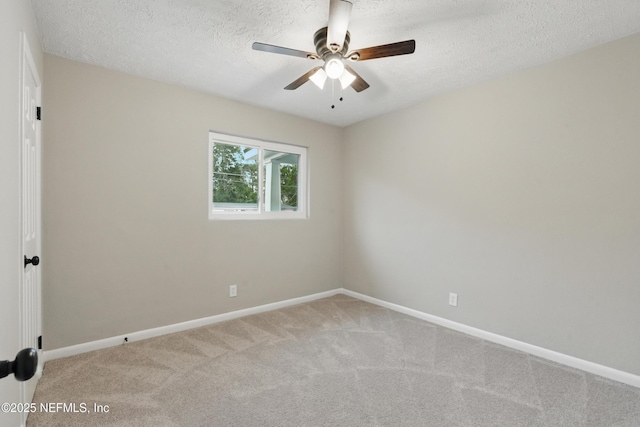 carpeted empty room featuring a ceiling fan, baseboards, and a textured ceiling