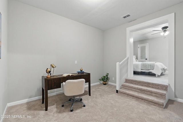 office area with baseboards, visible vents, carpet floors, and ceiling fan