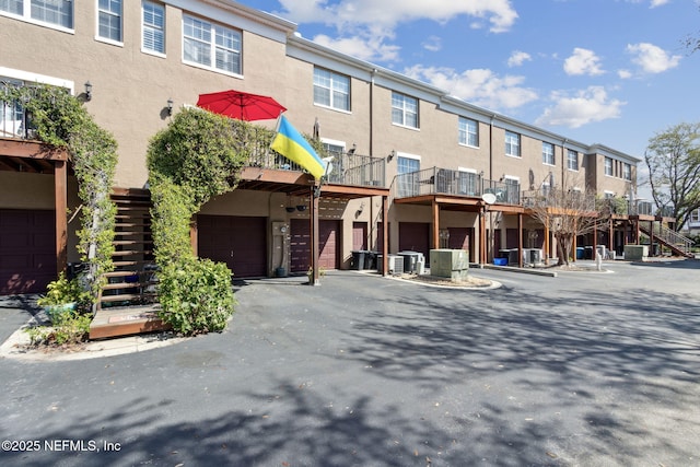 view of building exterior with a garage and a residential view