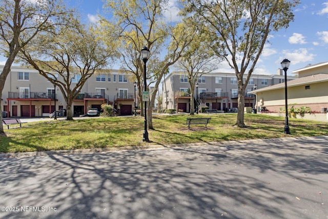 view of front of house featuring a front lawn and a residential view