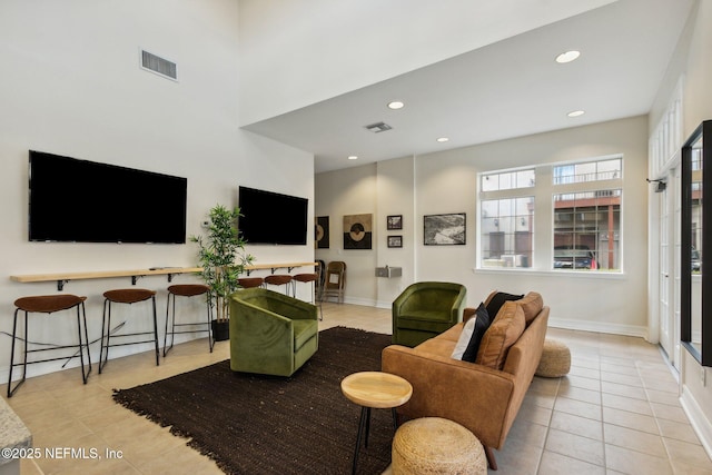 living room with tile patterned flooring, recessed lighting, visible vents, and baseboards