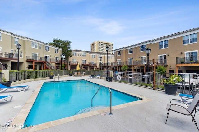 pool featuring a patio area and fence