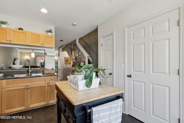 kitchen with light brown cabinets, visible vents, recessed lighting, a sink, and dark countertops