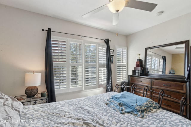 bedroom with multiple windows and a ceiling fan