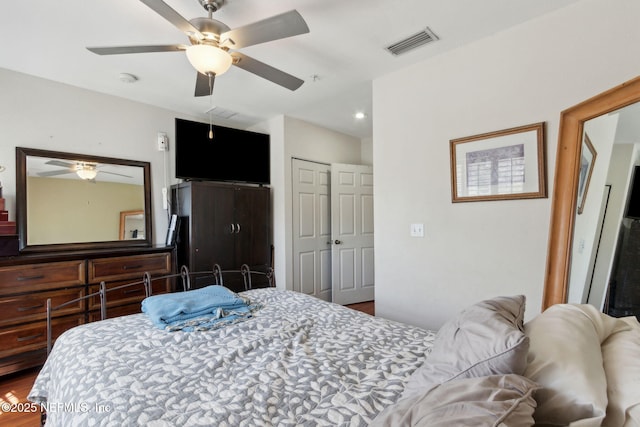 bedroom with a closet, visible vents, and ceiling fan