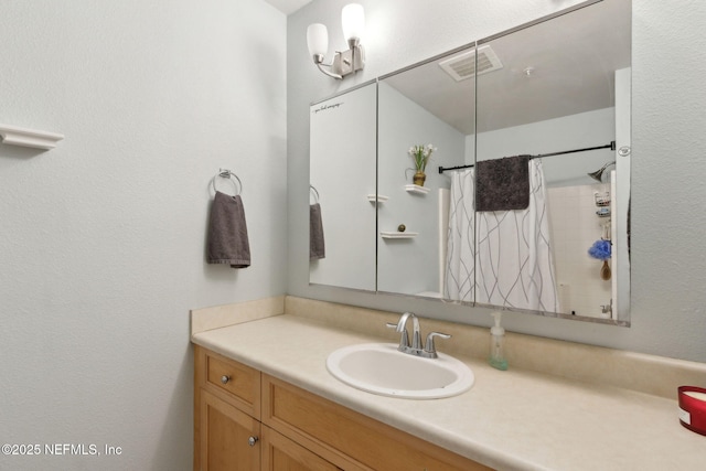 full bathroom with visible vents, a shower with curtain, and vanity